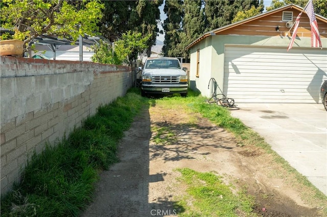 9925 Woodrich Ln, El Monte, CA 91731 - view of home's exterior featuring concrete driveway, fence, and a garage