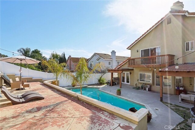 view of swimming pool with a fenced backyard, a patio area, and a fenced in pool