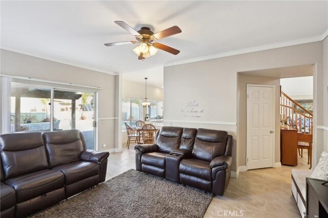 living area featuring a ceiling fan, light tile patterned flooring, stairs, and crown molding