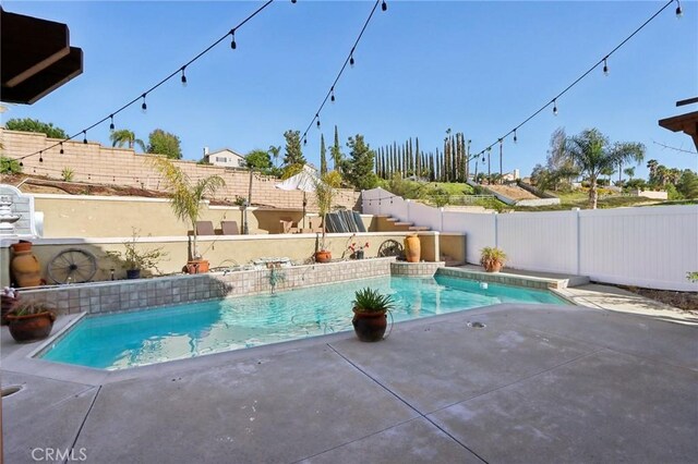 view of swimming pool featuring a fenced in pool, a patio, and a fenced backyard