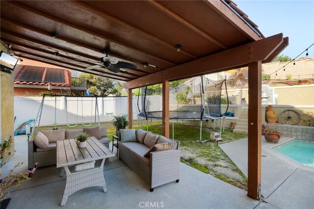 view of patio featuring a fenced backyard, outdoor lounge area, ceiling fan, and a trampoline