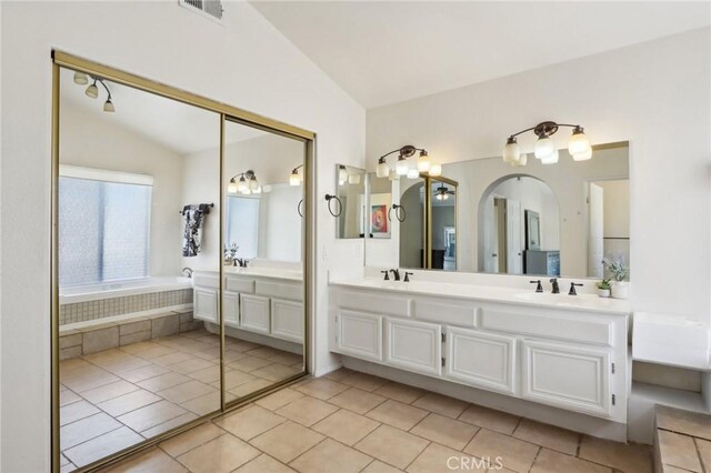 40540 Windsor Rd, Temecula, CA 92591 - bathroom featuring lofted ceiling, double vanity, tile patterned floors, and a garden tub
