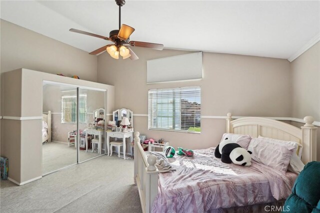 bedroom with vaulted ceiling, a ceiling fan, carpet flooring, and multiple windows