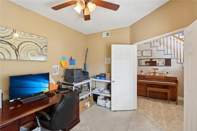 office space featuring visible vents and a ceiling fan