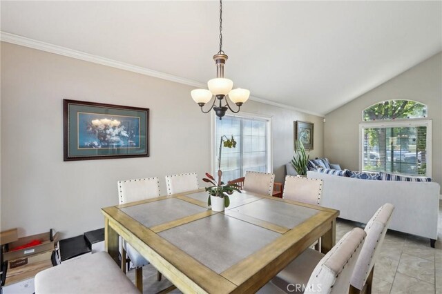 dining room with an inviting chandelier, ornamental molding, vaulted ceiling, and light tile patterned floors