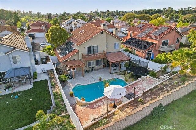 view of swimming pool featuring a residential view, a fenced in pool, a fenced backyard, a gazebo, and a patio