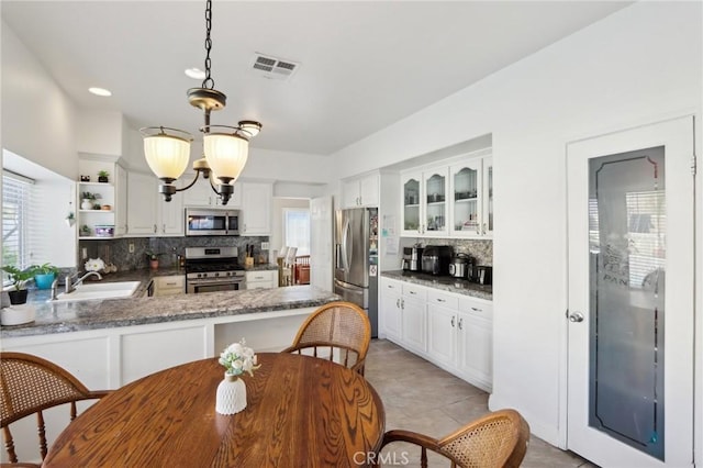 40540 Windsor Rd, Temecula, CA 92591 - kitchen featuring appliances with stainless steel finishes, a sink, tasteful backsplash, open shelves, and glass insert cabinets