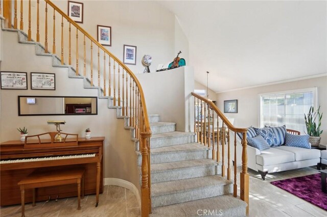 staircase featuring baseboards and crown molding