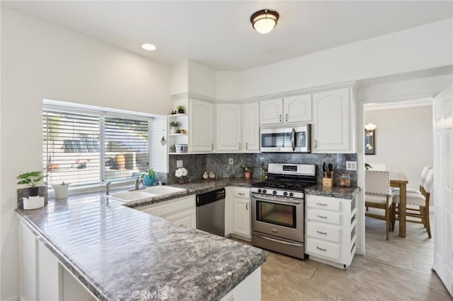 40540 Windsor Rd, Temecula, CA 92591 - kitchen with appliances with stainless steel finishes, decorative backsplash, open shelves, and a peninsula
