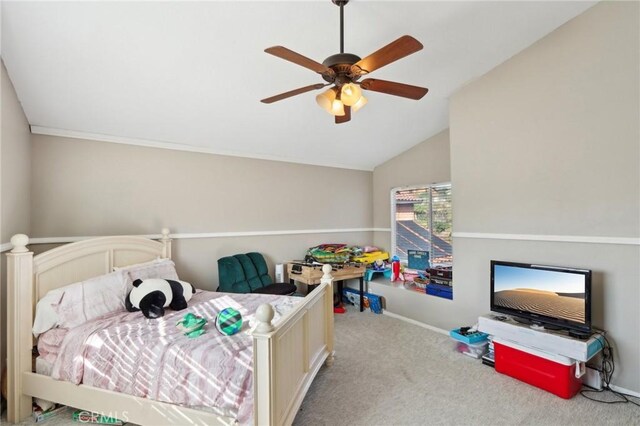 carpeted bedroom with lofted ceiling, a ceiling fan, and baseboards