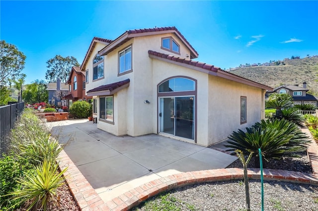 17328 Cold Spring Cir, Riverside, CA 92503 - back of property featuring stucco siding, a patio, a tiled roof, and fence