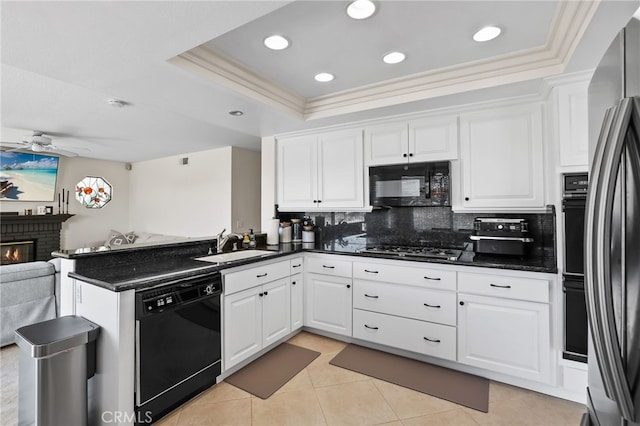 17328 Cold Spring Cir, Riverside, CA 92503 - kitchen featuring black appliances, white cabinets, open floor plan, tasteful backsplash, and a peninsula