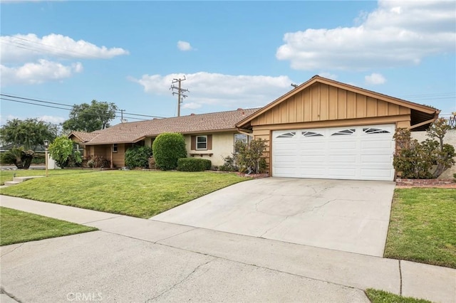 ranch-style house featuring an attached garage, stucco siding, driveway, and a front yard