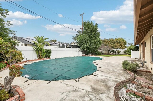 view of swimming pool featuring a patio, a fenced in pool, and a fenced backyard