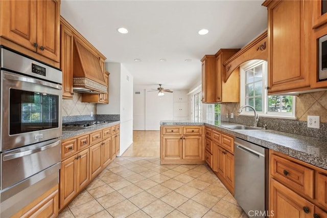 kitchen with a ceiling fan, appliances with stainless steel finishes, a sink, a warming drawer, and recessed lighting