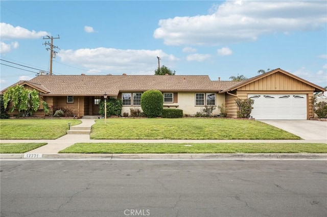 single story home with an attached garage, a front lawn, and concrete driveway