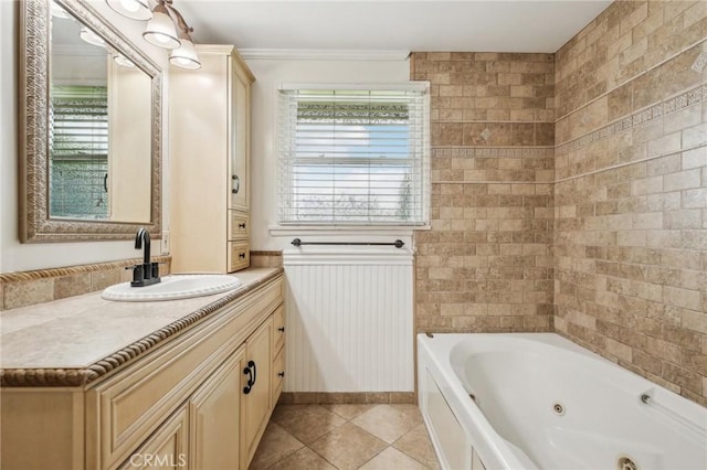 full bathroom with vanity, ornamental molding, wainscoting, a whirlpool tub, and tile patterned floors