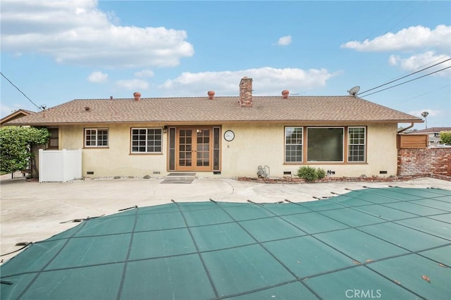 back of house featuring a fenced in pool, stucco siding, crawl space, and fence