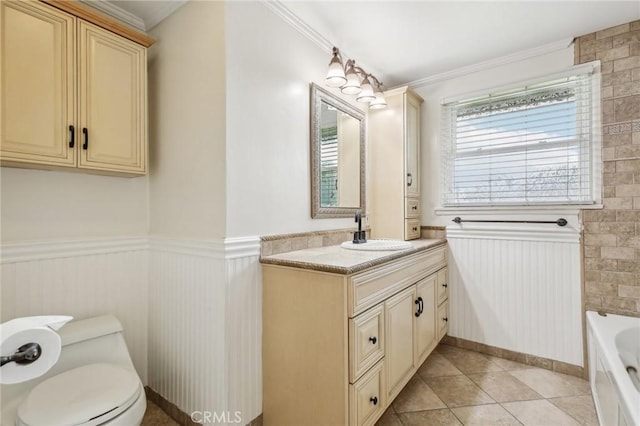 full bath with vanity, crown molding, wainscoting, tile patterned flooring, and a washtub