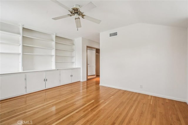 spare room featuring ceiling fan, baseboards, visible vents, and wood finished floors