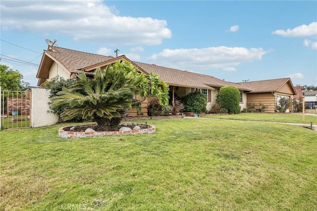ranch-style home with fence, stucco siding, and a front lawn