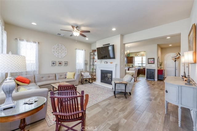 living room with light wood-style floors, ceiling fan, plenty of natural light, and recessed lighting