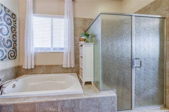 full bath with a bath and a stall shower