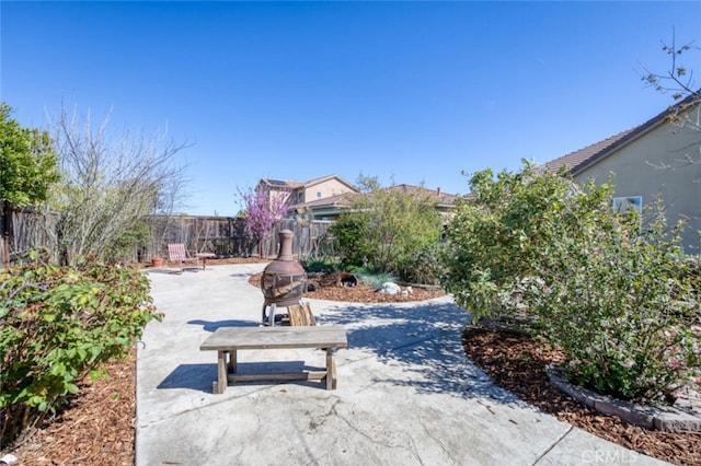 view of community with a patio area and a fenced backyard