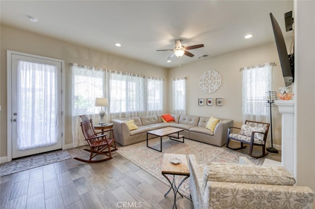 living area featuring visible vents, ceiling fan, plenty of natural light, and recessed lighting