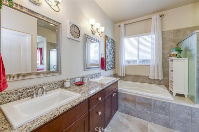 full bath with a sink, double vanity, a shower with door, and a garden tub