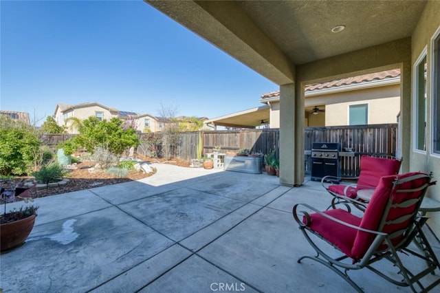 view of patio / terrace featuring a fenced backyard and a grill