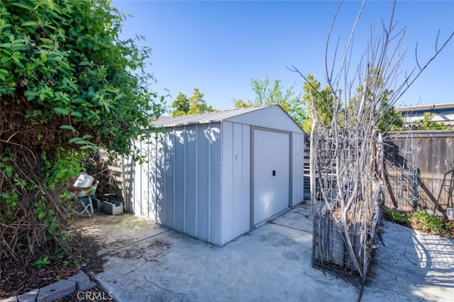 view of shed featuring fence