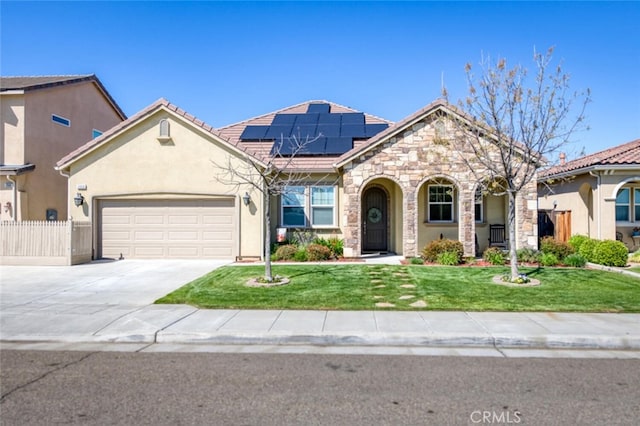 view of front of property with driveway, a front lawn, solar panels, a garage, and fence