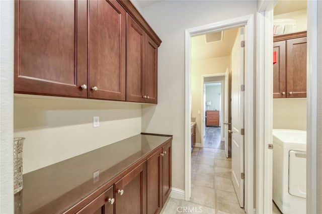 hallway with washer / clothes dryer, light tile patterned floors, baseboards, and visible vents