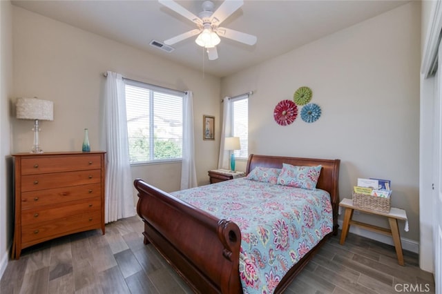 bedroom featuring visible vents, ceiling fan, wood finished floors, and baseboards