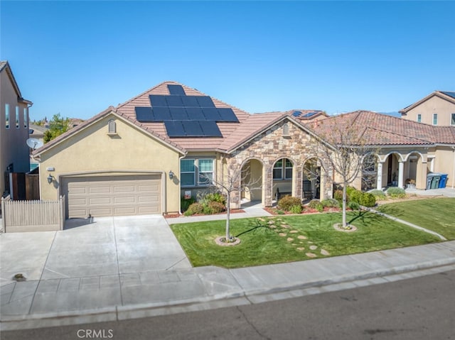 mediterranean / spanish-style home with stucco siding, driveway, an attached garage, a front yard, and a tile roof
