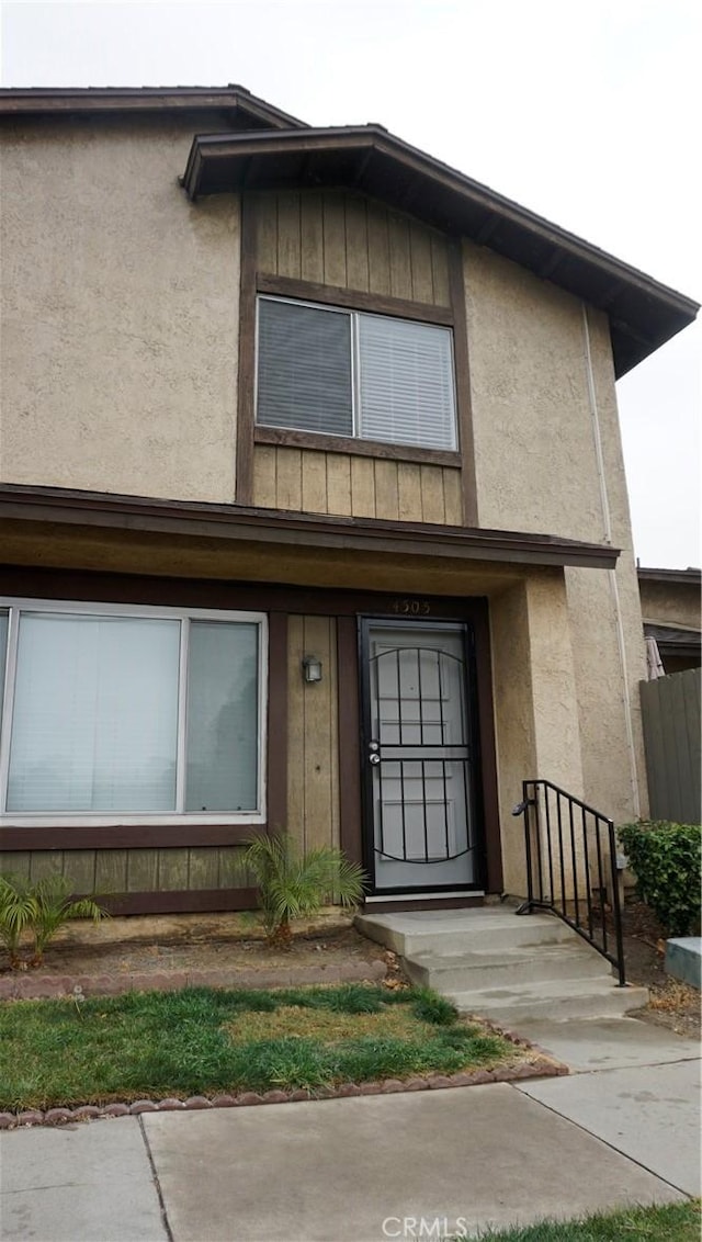 townhome / multi-family property with board and batten siding and stucco siding