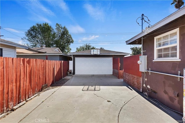 detached garage featuring fence