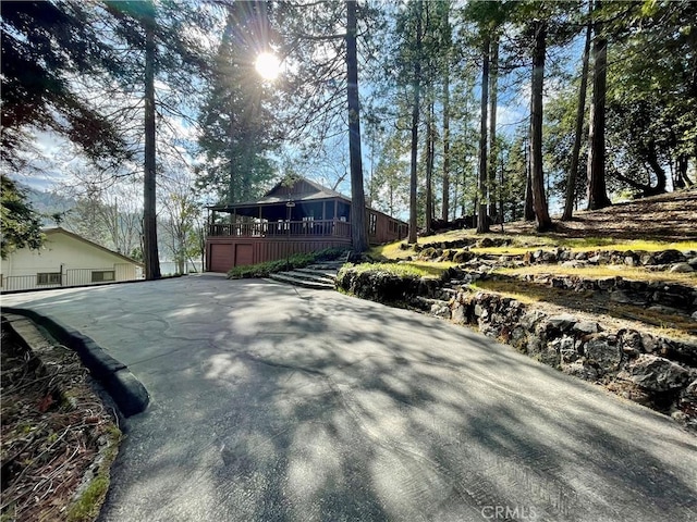 39121 Lake Dr, Bass Lake, CA 93604 - view of side of property with an attached garage, a deck, and driveway
