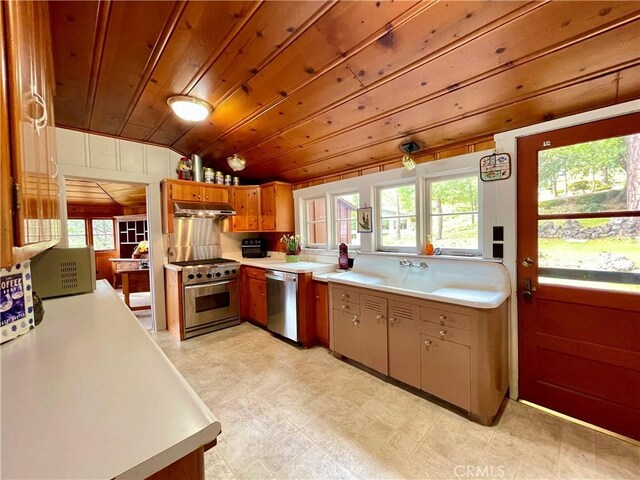 39121 Lake Dr, Bass Lake, CA 93604 - kitchen with stainless steel appliances, light countertops, under cabinet range hood, healthy amount of natural light, and wooden ceiling