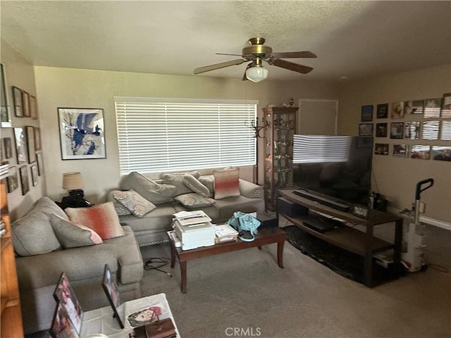 living area with carpet and a ceiling fan