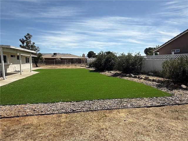 view of yard with a patio and a fenced backyard