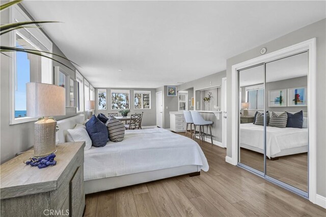 bedroom with wood finished floors and baseboards