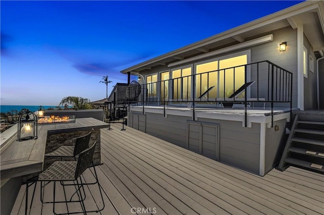 wooden deck with stairway and an outdoor fire pit