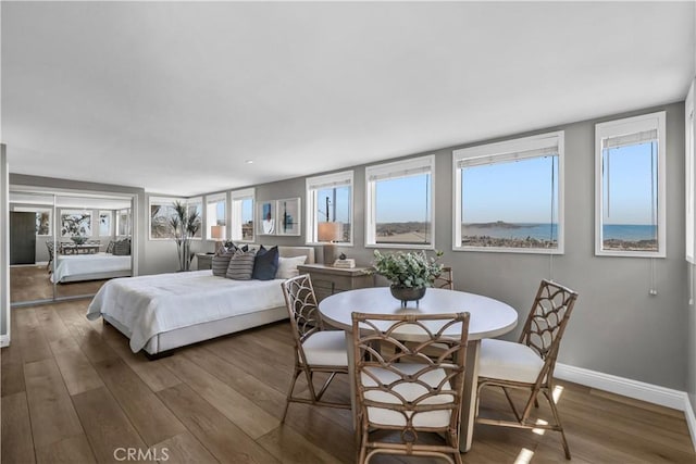 bedroom featuring wood finished floors and baseboards