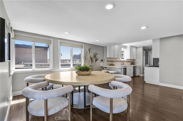 dining space with baseboards, dark wood-style floors, and recessed lighting