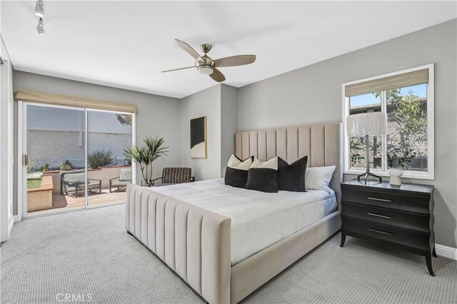 bedroom with access to outside, a ceiling fan, and carpet floors