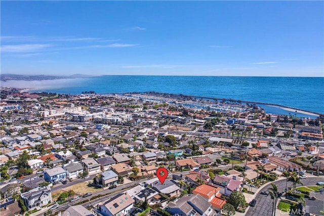 drone / aerial view with a water view and a residential view