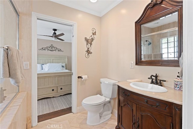 ensuite bathroom with connected bathroom, an enclosed shower, toilet, ceiling fan, and vanity