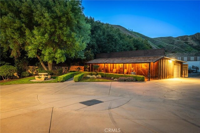 view of front of house featuring a mountain view and concrete driveway